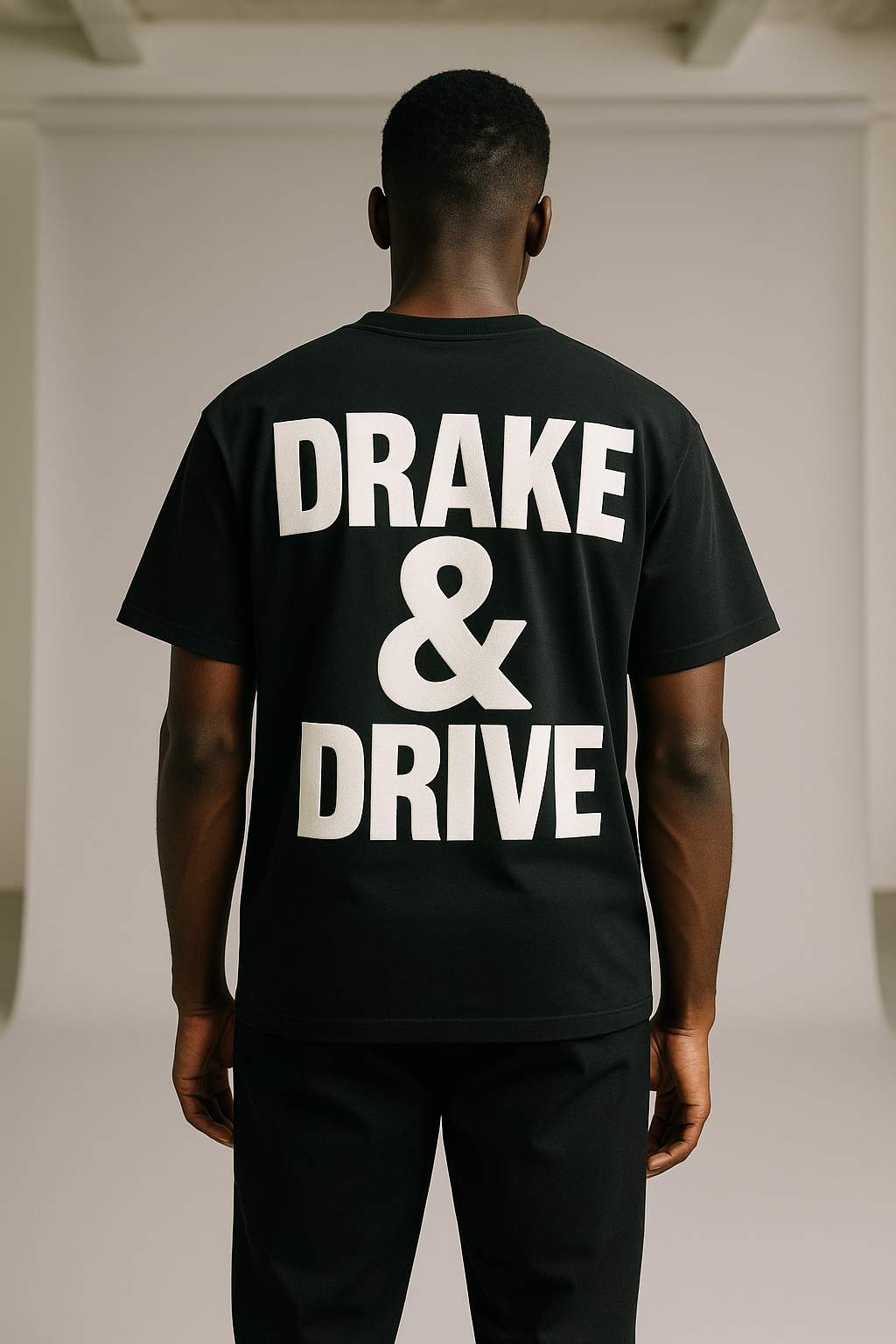 Male model wearing Drake & Drive tee, back view showing print